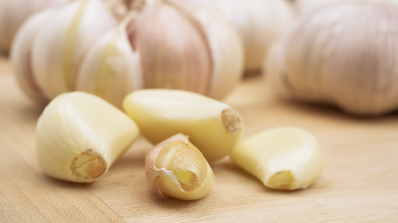 Garlic cloves separated from bulb on cutting board