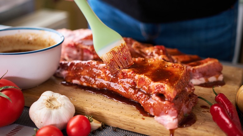 brushing marinade on ribs
