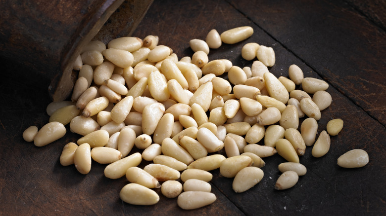 Pine nuts spilling out of jar