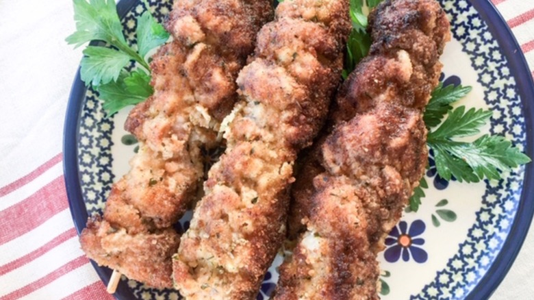 Several pieces of city chicken on a decorative blue and white plate