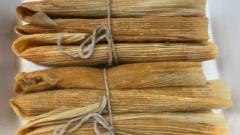Bundle of Delta tamales on a white plate