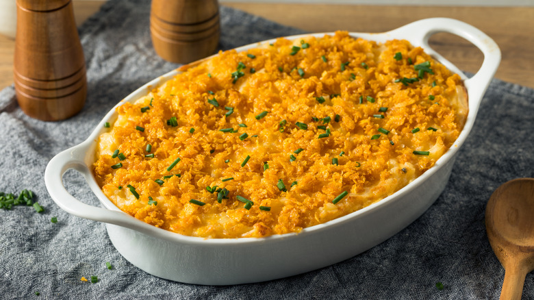 Funeral potatoes in an oval white baking dish