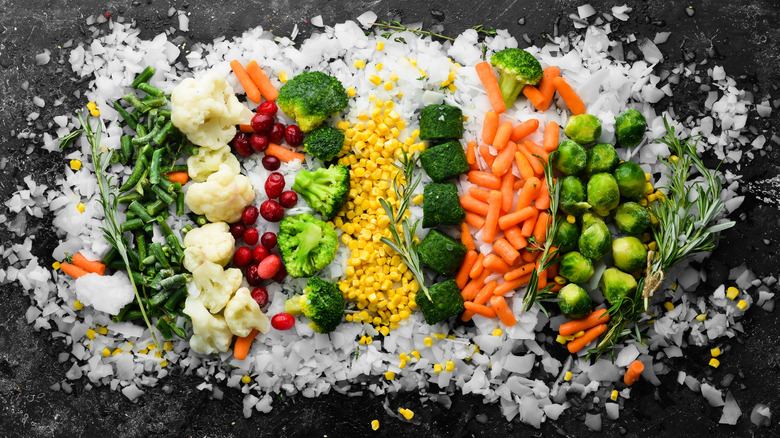 Aerial view of assorted frozen vegetables on shaved ice