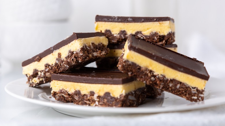 Nanaimo bars stacked on plate