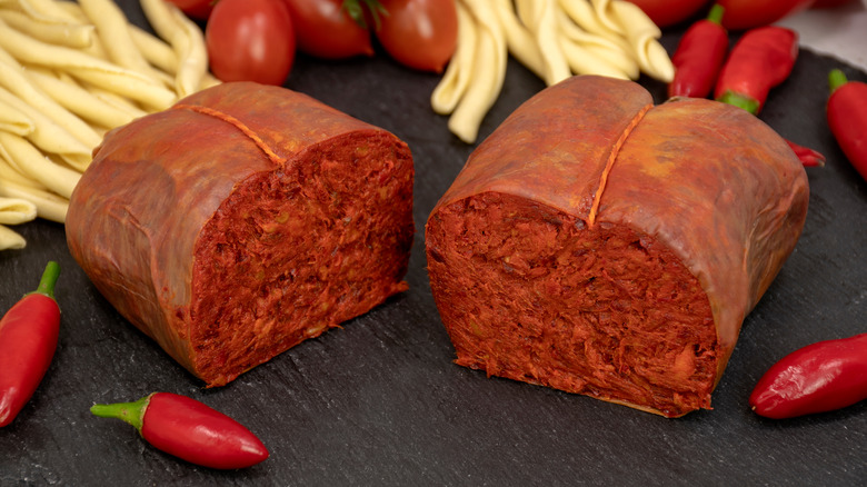 'Nduja next to tomatoes, chilies, and pasta