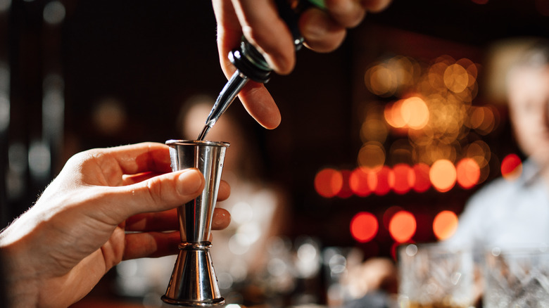 bartender pouring into jigger