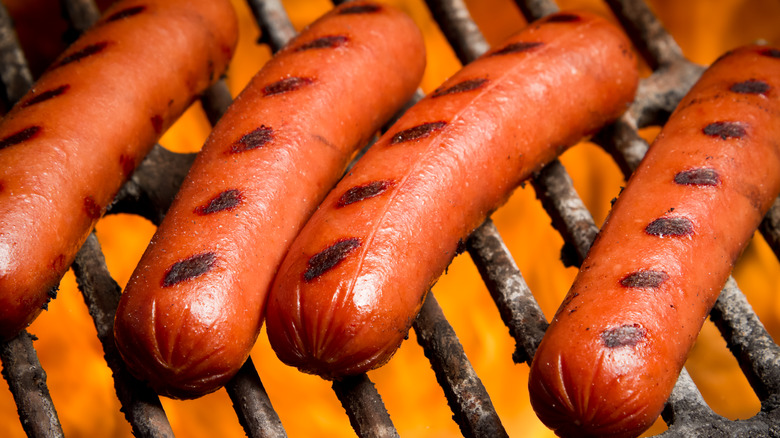 Hot dogs cooking on a grill