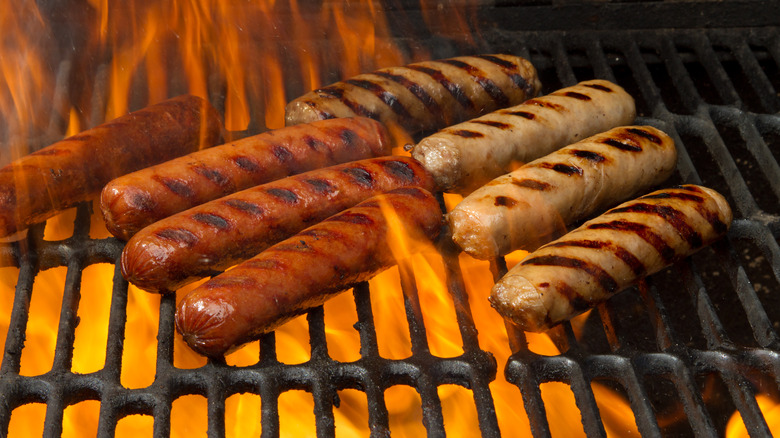 Hot dogs and sausages cooking on a grill