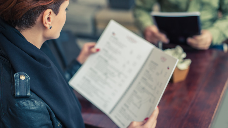 woman looking at menu