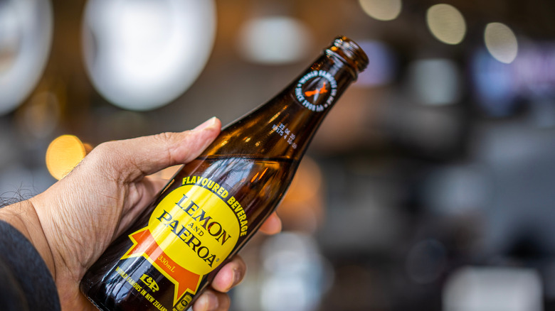 holding Lemon & Paeroa bottle