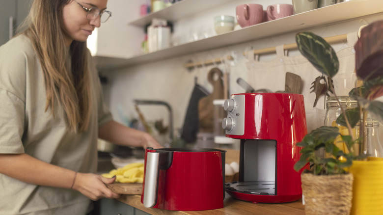 woman using air fryer