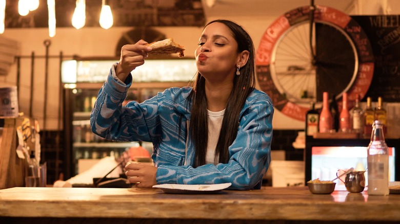diner enjoying pizza alone