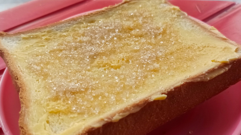 Buttered bread sprinkled with sugar