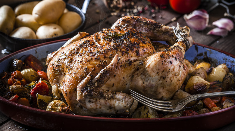 roast chicken on platter, vegetables