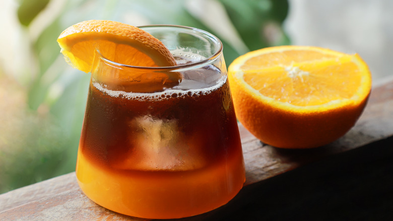 Cup of coffee with sliced orange