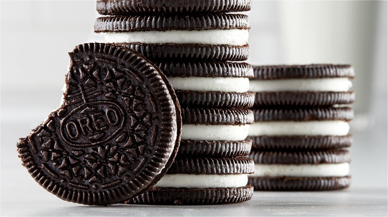 A mound of Oreo cookies on a wooden surface 