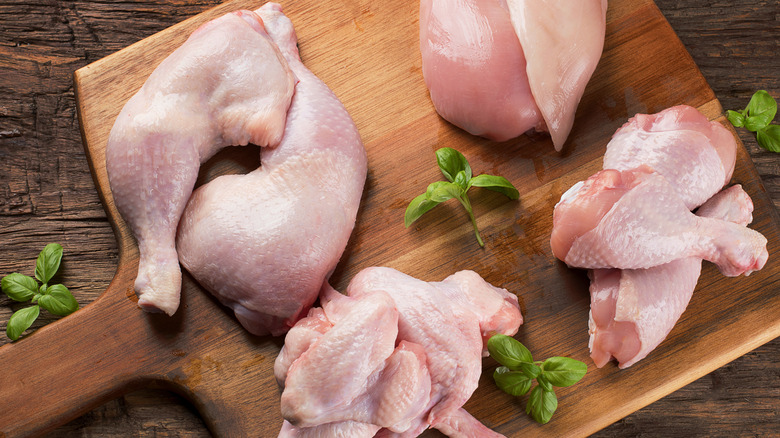 Raw chicken meat on wooden board