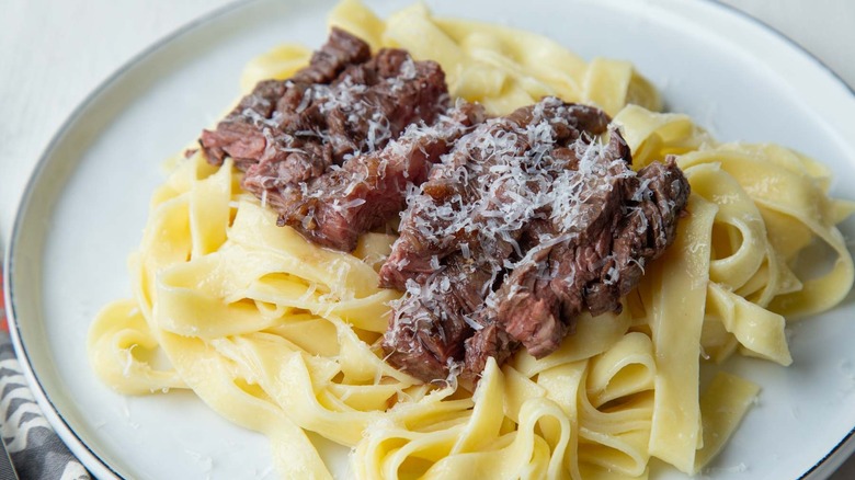 Steak Alfredo pasta on plate
