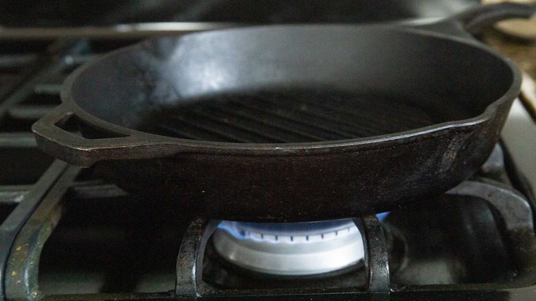 Cast iron skillet heating on stove