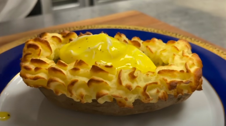 Elaborately presented Eggs Suzette, baked and topped with hollandaise