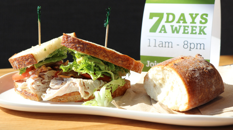 A sandwich and a piece of bread from Panera Bread on a plate