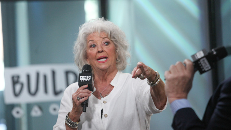 paula deen speaking into microphone
