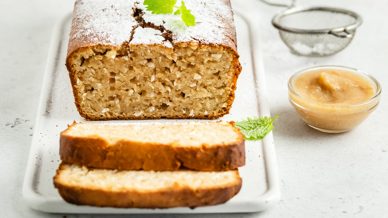 sliced apple bread with glass dish of apple sauce