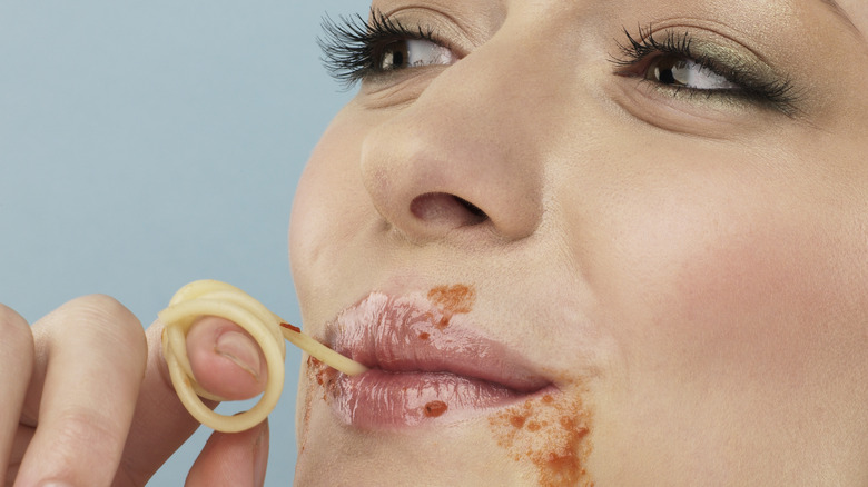 Marinara sauce on woman's face