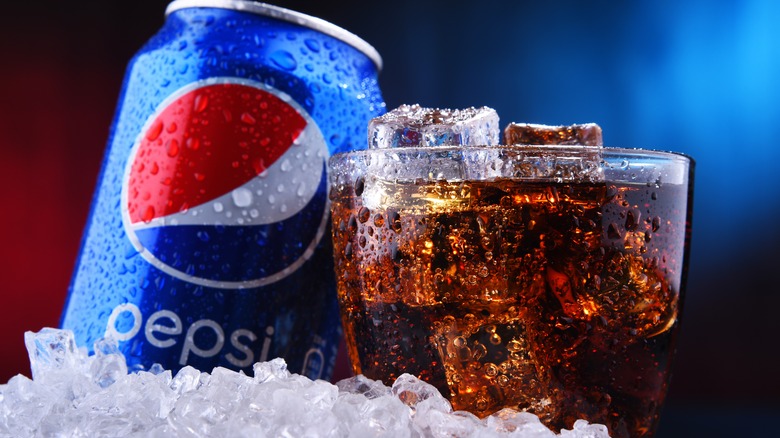 Can and glass of Pepsi on ice