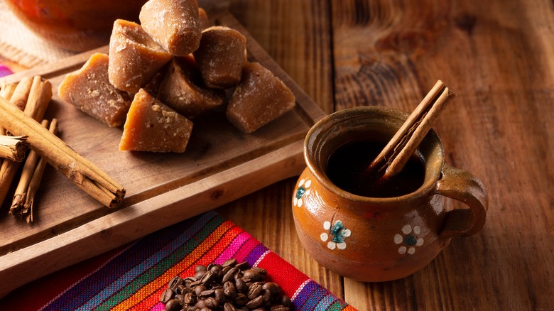 Piloncillo beside Mexican ceramic pot