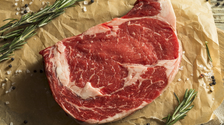 Raw cut of well marbled ribeye steak