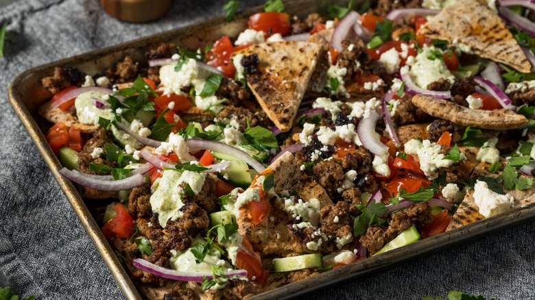 Greek nachos on baking sheet