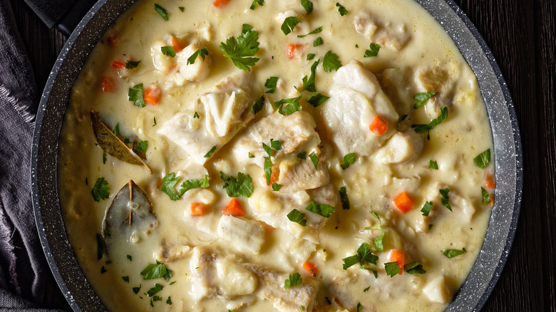 fish poached in milk served in a pan