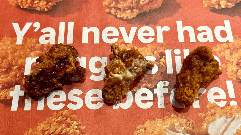 three Popeyes wings on tray