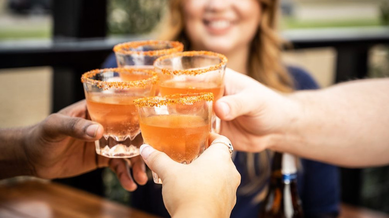 women cheersing with Mexican candy shots at bar