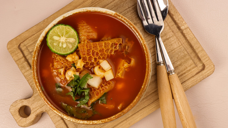 Menudo in bowl with utensils