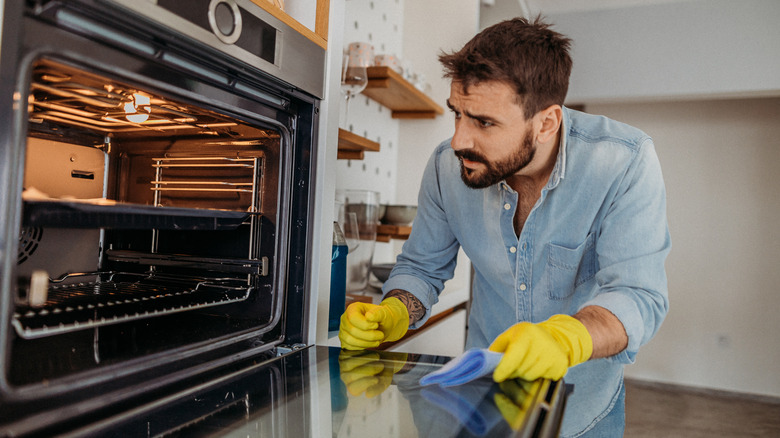 Person cleaning the oven