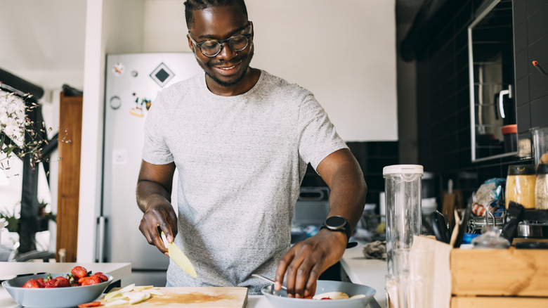 man meal prepping in kitchen