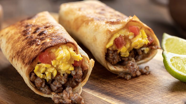 toasted breakfast burrito served with lime
