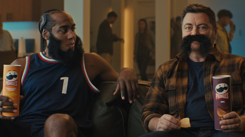 James Harden and Nick Offerman in a Pringles ad sitting on a couch at a party,