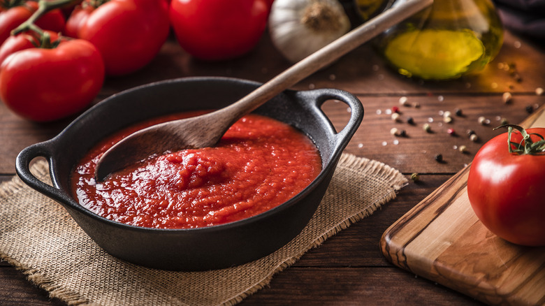 cast iron pan of tomato sauce on table