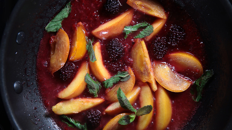 peaches and blackberries cooked in a pan