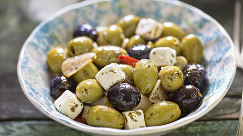 Olives and cheese in a bowl