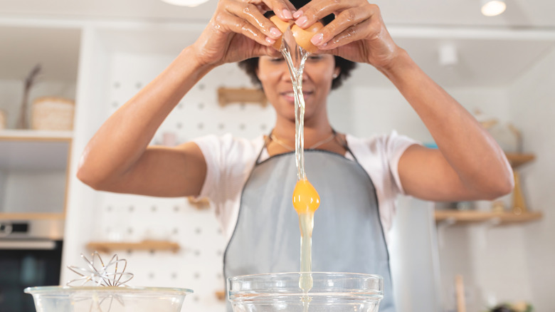 woman cracking egg into bowl