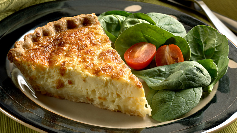 Slice of cheese quiche with spinach