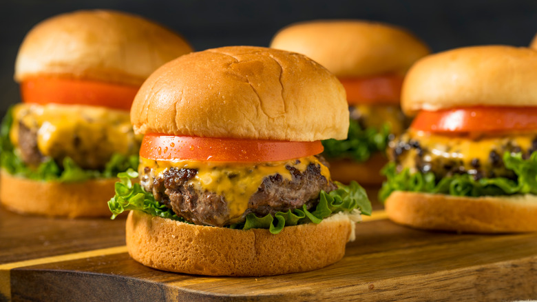 gourmet burgers on wood board