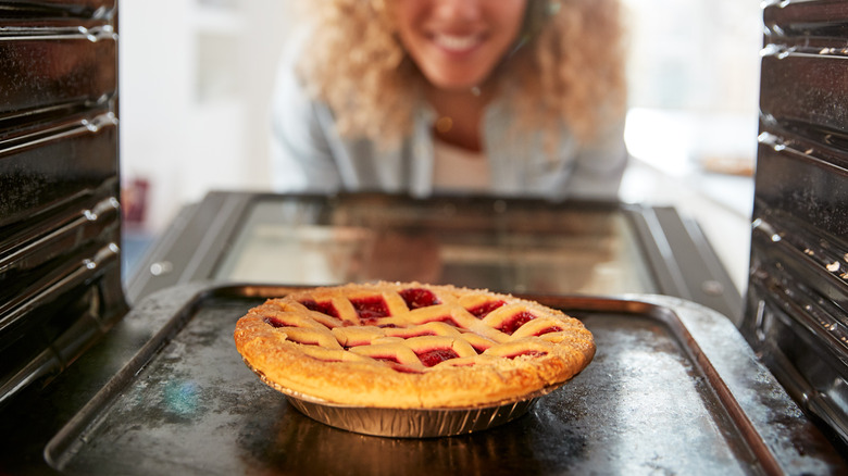 taking pie out of oven