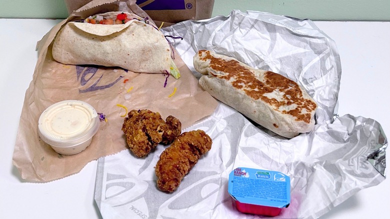 Several Taco Bell menu items together against a green and white background