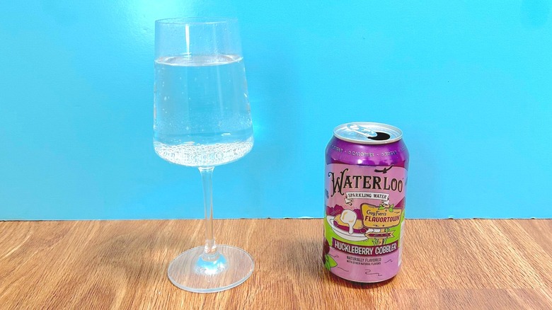 Glass and can of Waterloo Sparkling Water and Guy Fieri's Flavortown Huckleberry Cobbler