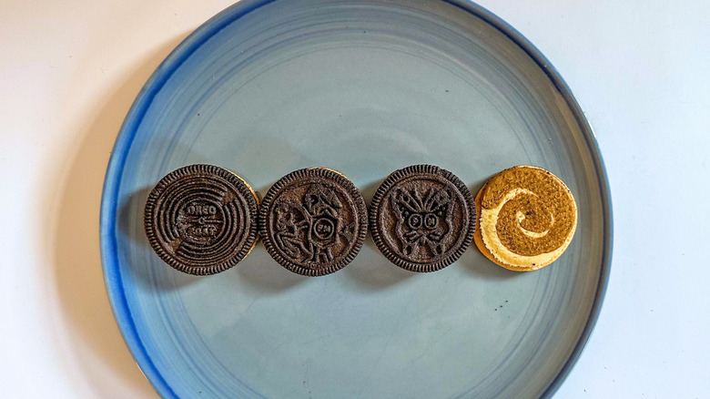 Four Oreo cookies on a blue plate